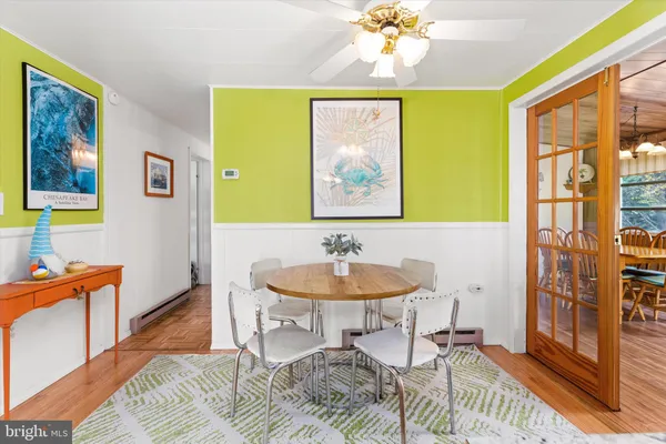a view of a dining room with furniture and a chandelier