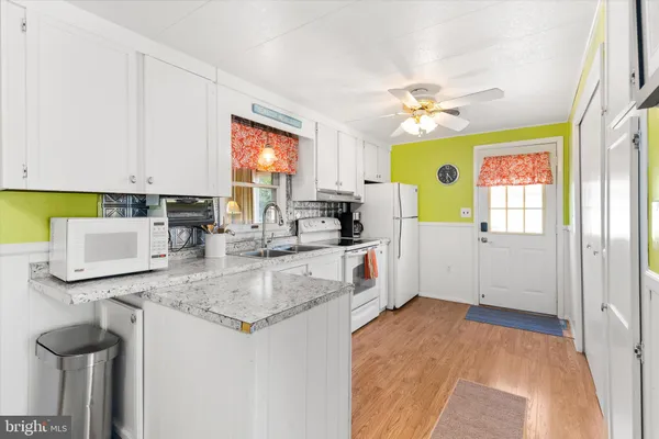 a kitchen with a sink cabinets and window