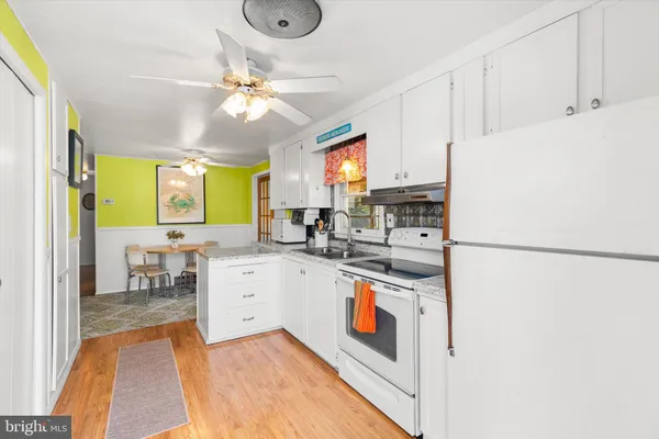 a kitchen with stainless steel appliances a refrigerator sink and cabinets