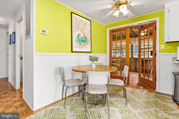 a view of a dining room with furniture and chandelier