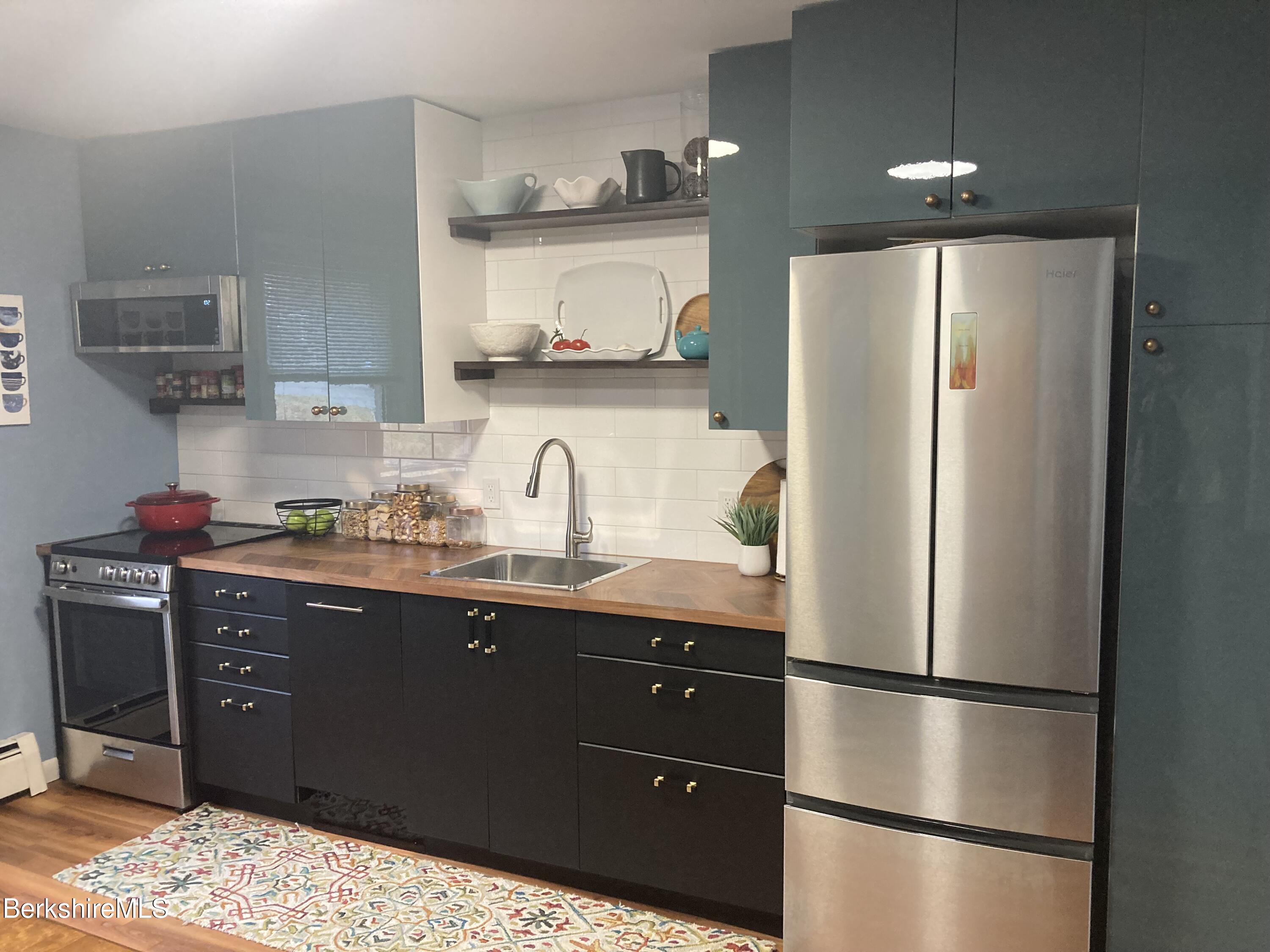 2 Morgan Manor, Unit 6 Lenox, MA 01240 - Photo 15 of 32 a kitchen with stainless steel appliances granite countertop a refrigerator a sink and a stove