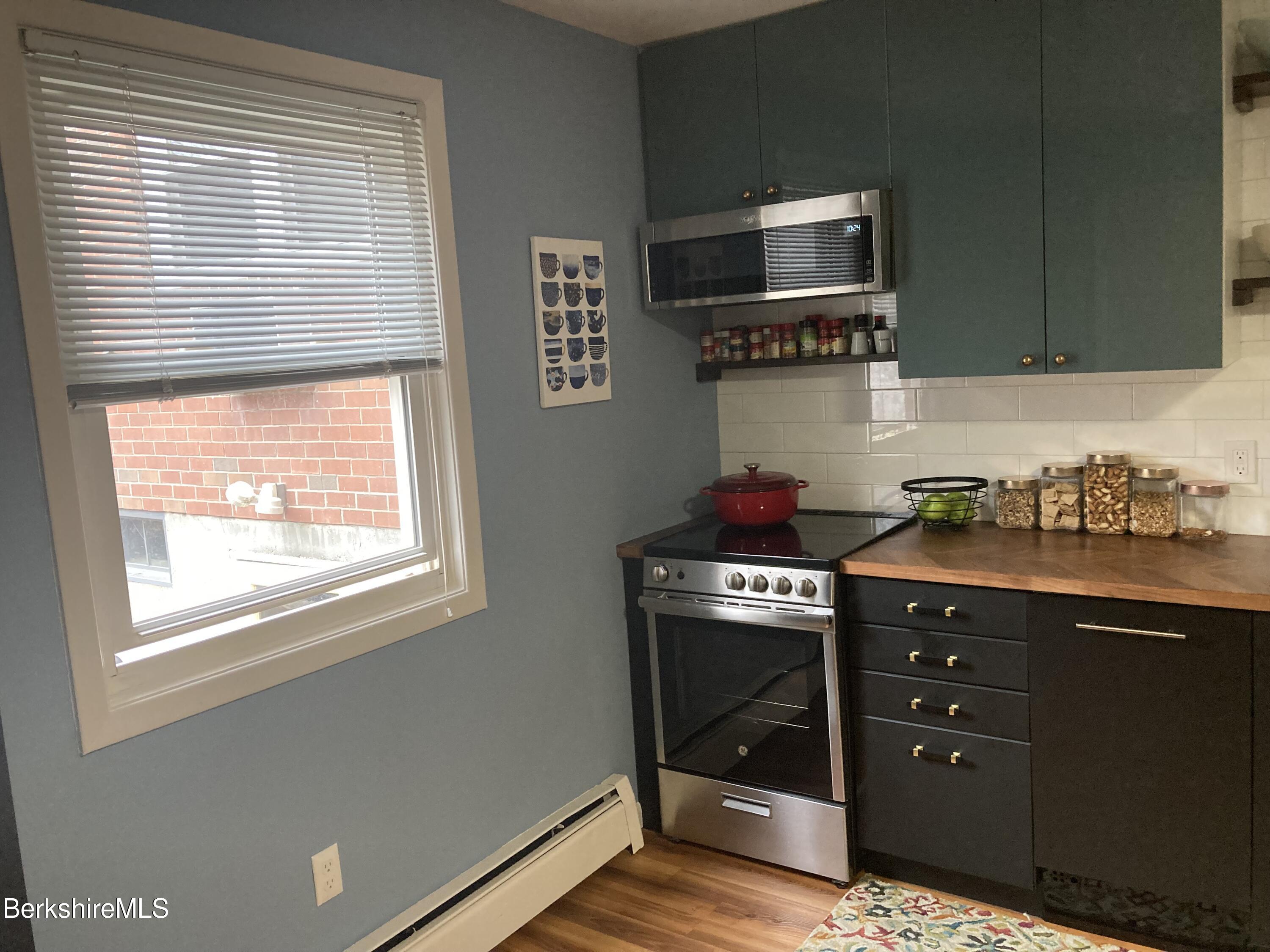 2 Morgan Manor, Unit 6 Lenox, MA 01240 - Photo 17 of 32 a kitchen with stainless steel appliances granite countertop a stove a sink and a microwave