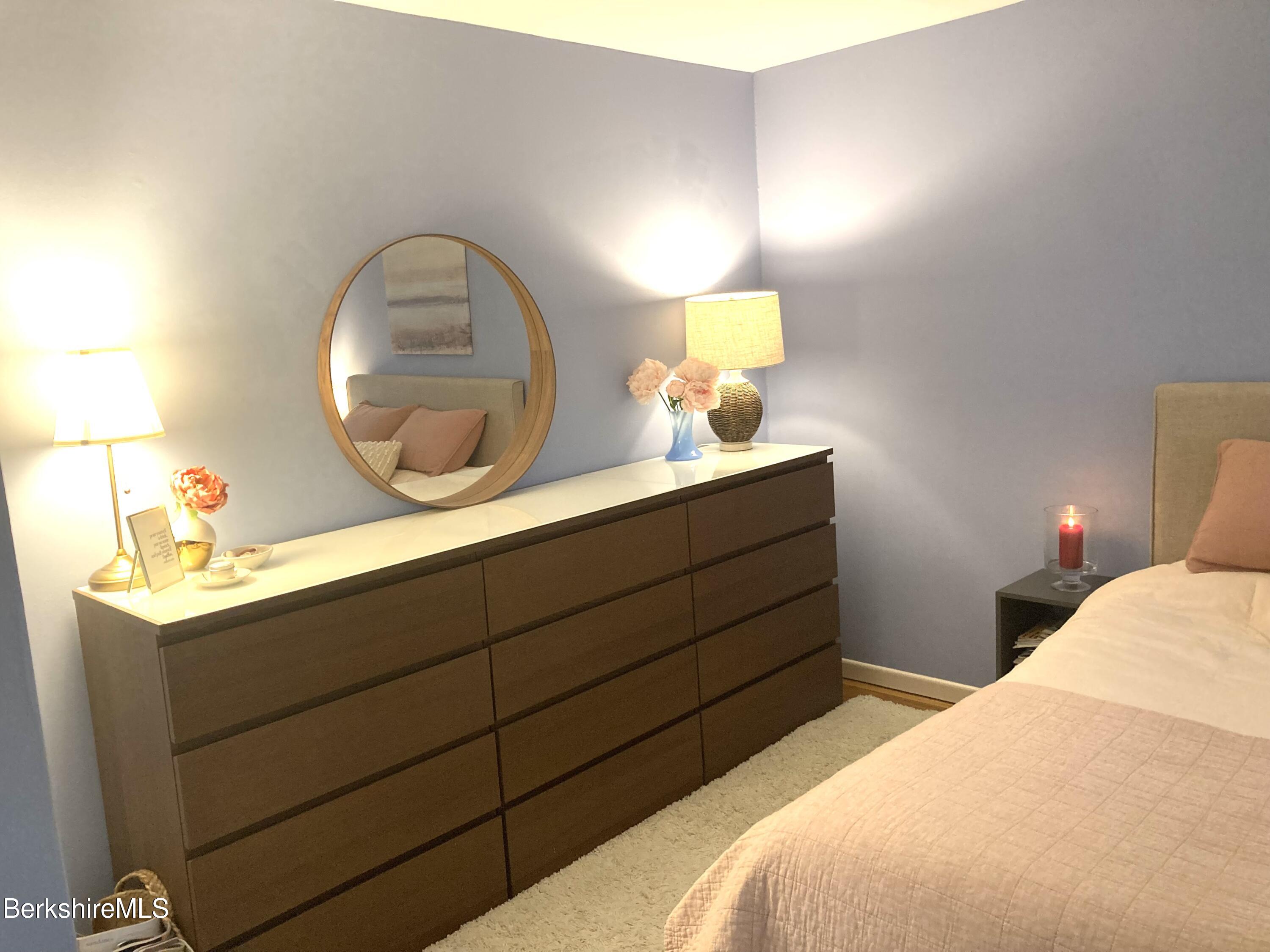 2 Morgan Manor, Unit 6 Lenox, MA 01240 - Photo 22 of 32 a bedroom with a bed and a mirror