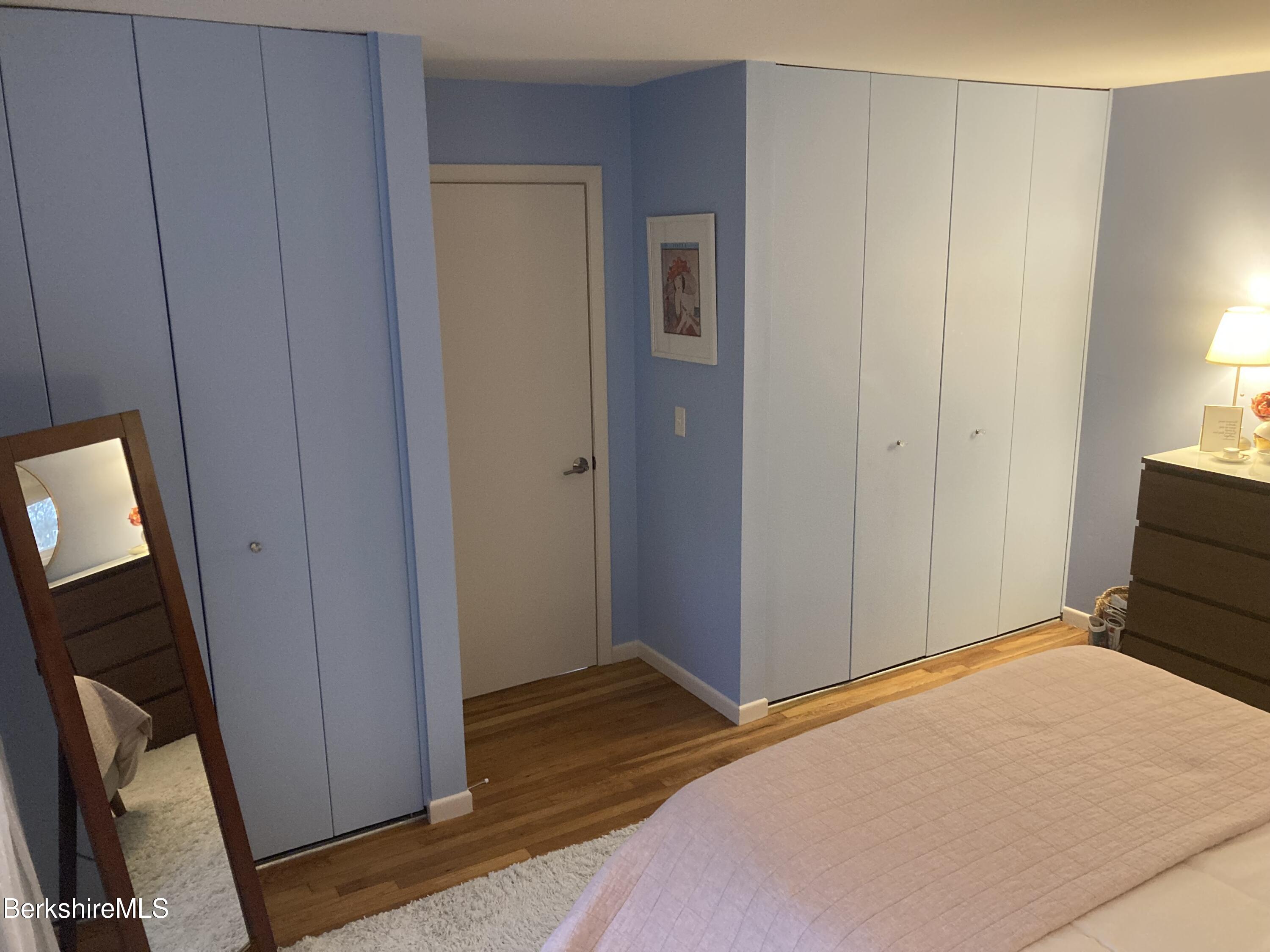 2 Morgan Manor, Unit 6 Lenox, MA 01240 - Photo 28 of 32 a bedroom with a bed and wooden floor