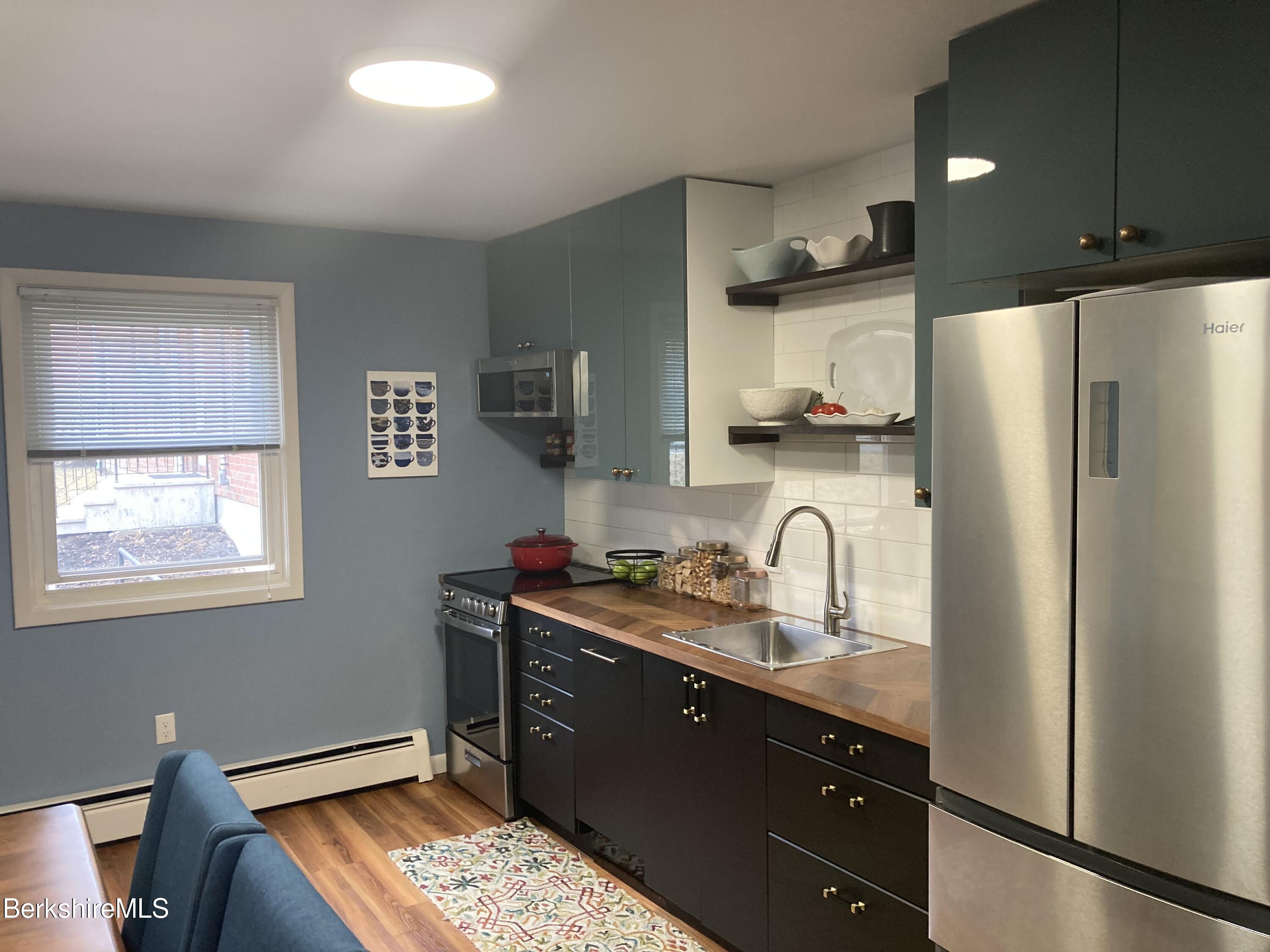 2 Morgan Manor, Unit 6 Lenox, MA 01240 - Photo 3 of 32 a kitchen with stainless steel appliances granite countertop a refrigerator stove and sink