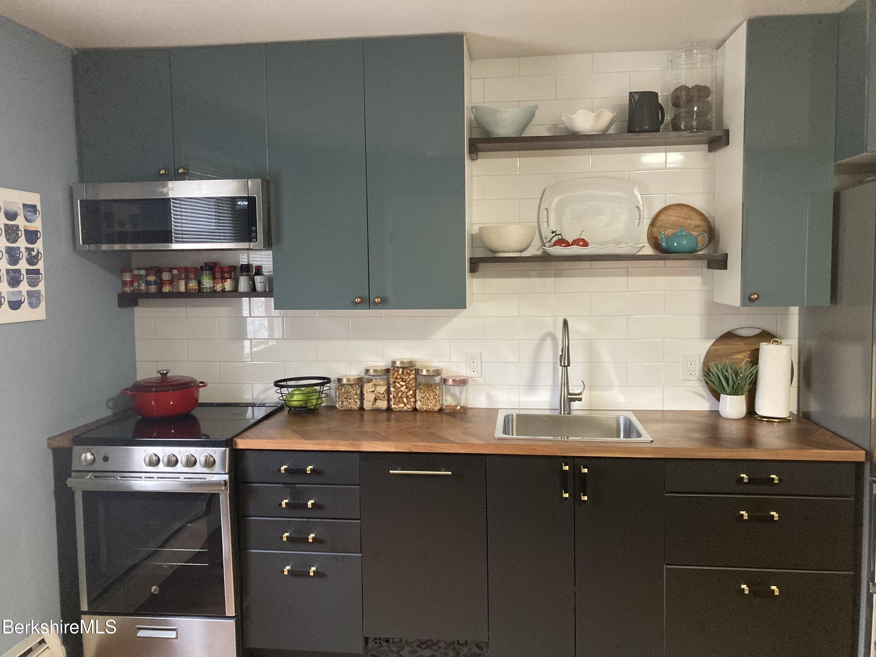 2 Morgan Manor, Unit 6 Lenox, MA 01240 - Photo 6 of 32 a kitchen with stainless steel appliances a sink dishwasher stove and cabinets