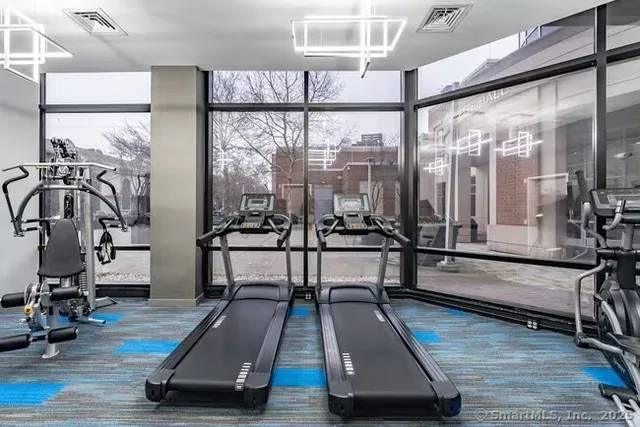 a room with gym equipment and a large window