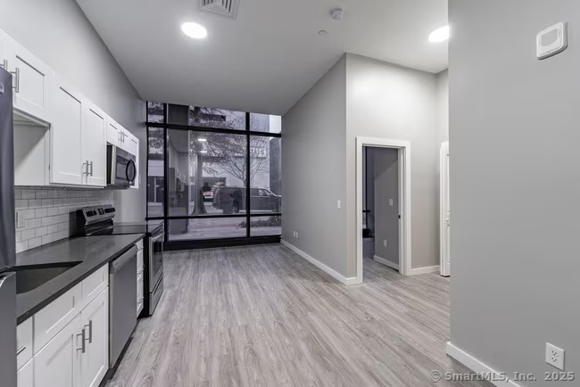 333 State Street, Unit 705 Bridgeport, CT 06604 - Photo 6 of 18 a view of a kitchen with electric appliances