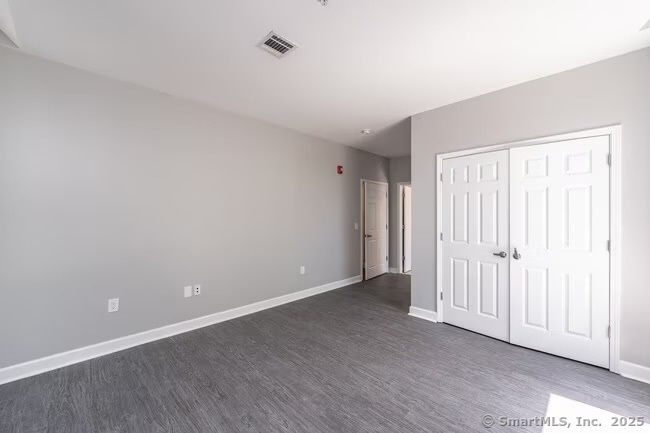 333 State Street, Unit 705 Bridgeport, CT 06604 - Photo 7 of 18 a view of an empty room with wooden floor