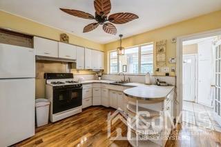 237 Amboy Road Old Bridge, NJ 07747 - Photo 15 of 39 a kitchen with a sink appliances and cabinets