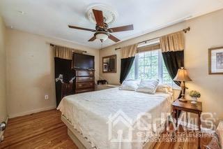237 Amboy Road Old Bridge, NJ 07747 - Photo 17 of 39 a bedroom with a bed and a flat tv screen on dresser