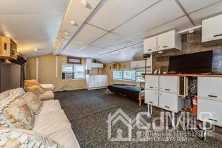 237 Amboy Road Old Bridge, NJ 07747 - Photo 23 of 39 a bed room with a bed furniture and a flat screen tv