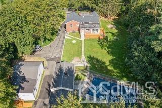 237 Amboy Road Old Bridge, NJ 07747 - Photo 3 of 39 an aerial view of a house with outdoor space and trees all around