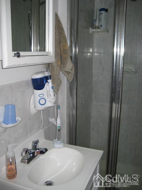 237 Amboy Road Old Bridge, NJ 07747 - Photo 33 of 39 a bathroom with a sink and a mirror