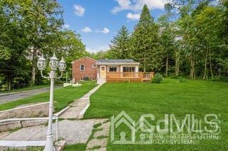 237 Amboy Road Old Bridge, NJ 07747 - Photo 7 of 39 a front view of a house with a yard table and chairs