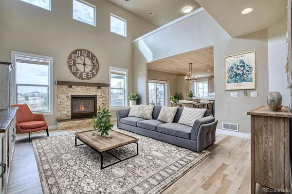 a kitchen with stainless steel appliances granite countertop a table chairs sink refrigerator and cabinets