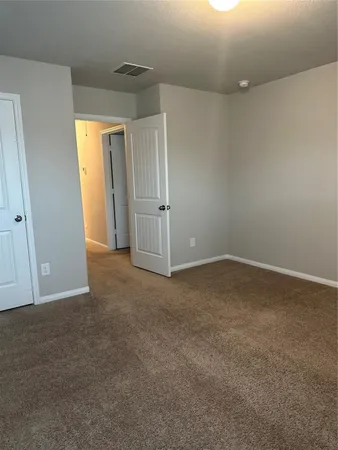 a view of an empty room and closet area