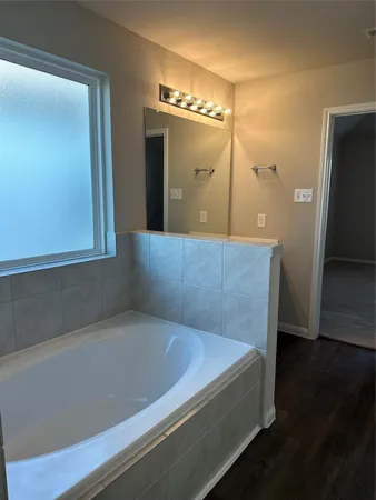 a spacious bathroom with a bathtub and a shower