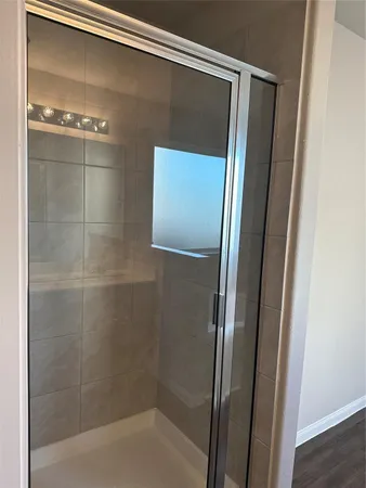 a bathroom with a glass shower door
