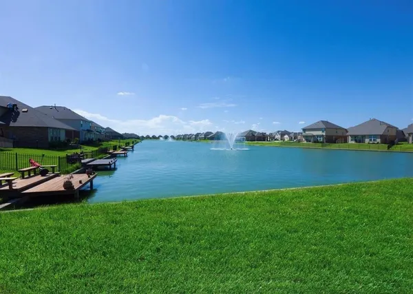 a view of a lake with houses in the background