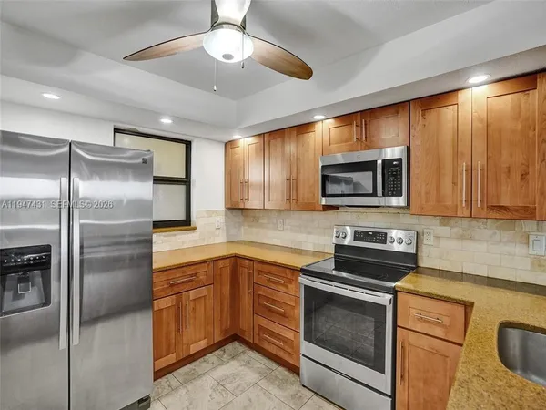a kitchen with a sink stove and microwave