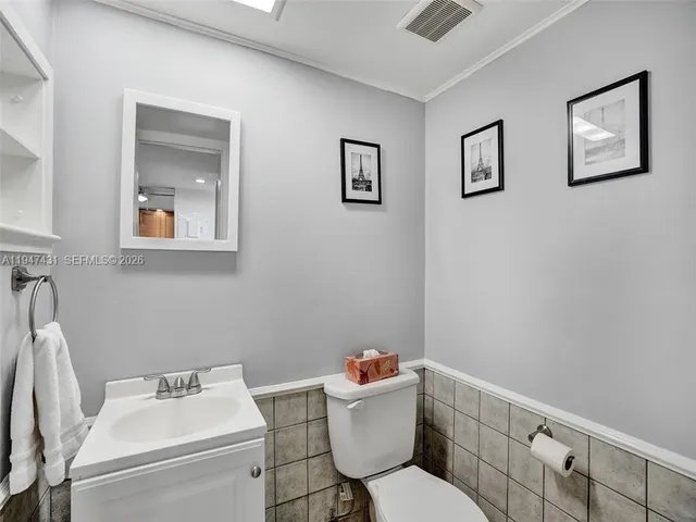 a living room with furniture kitchen and a window