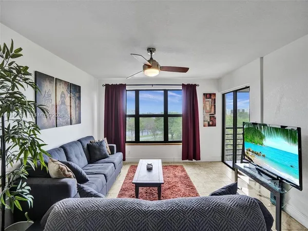a living room with furniture and a potted plant