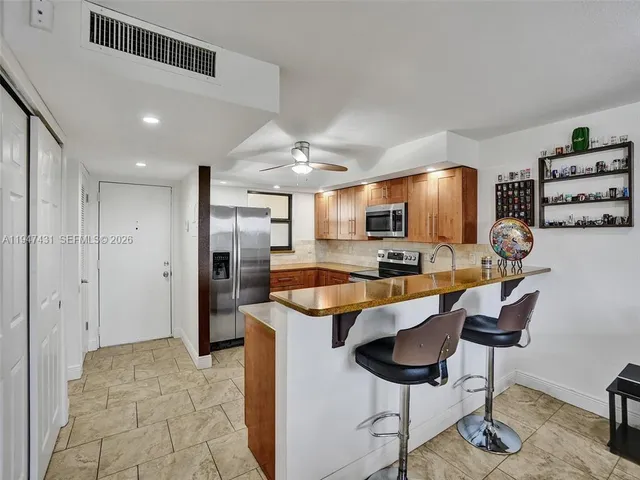a kitchen with a sink stainless steel appliances and cabinets