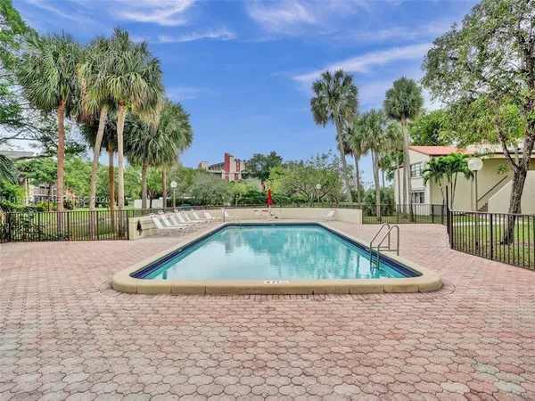 a kitchen with appliances a sink and cabinets