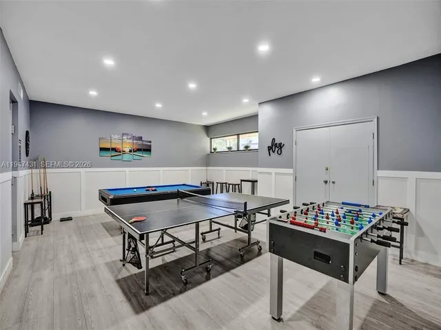 a bedroom with a bed and a dresser with mirror