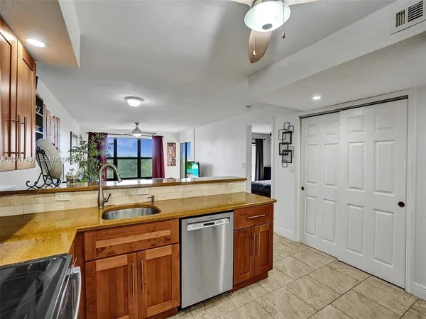 a kitchen with stainless steel appliances granite countertop a sink and cabinets