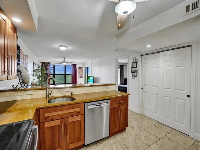 a kitchen with stainless steel appliances granite countertop a sink and cabinets
