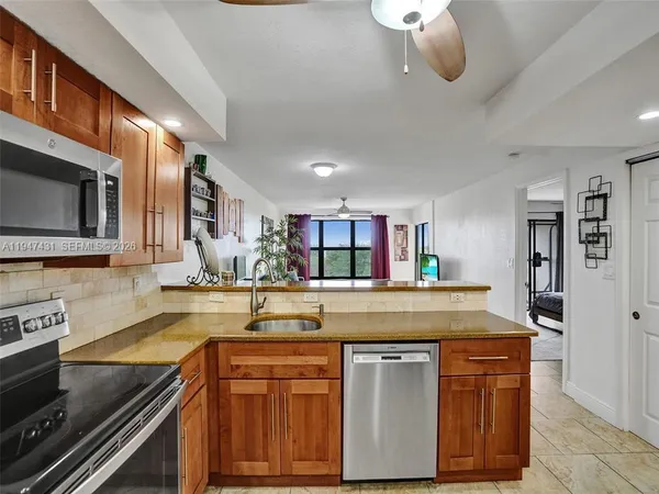 a kitchen with a refrigerator stove and microwave