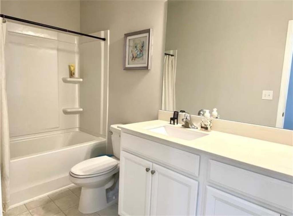 1719 Charcoal Ives Road Lawrenceville, GA 30045 - Photo 11 of 17 a bathroom with a sink a toilet and shower