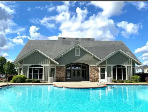 a view of a swimming pool with a lounge chair