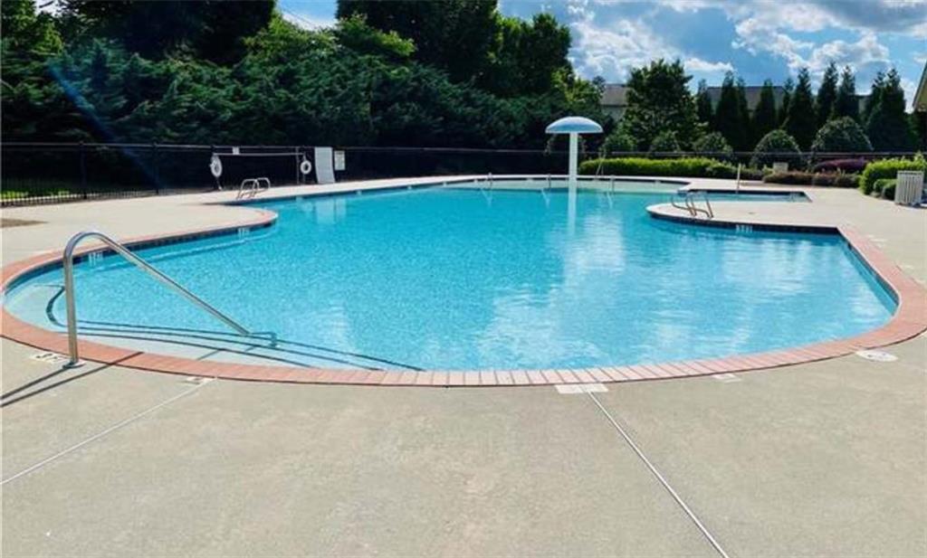 1719 Charcoal Ives Road Lawrenceville, GA 30045 - Photo 15 of 17 a view of a swimming pool with a lounge chair
