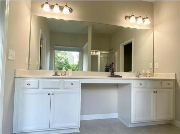 a bathroom with a sink vanity and mirror