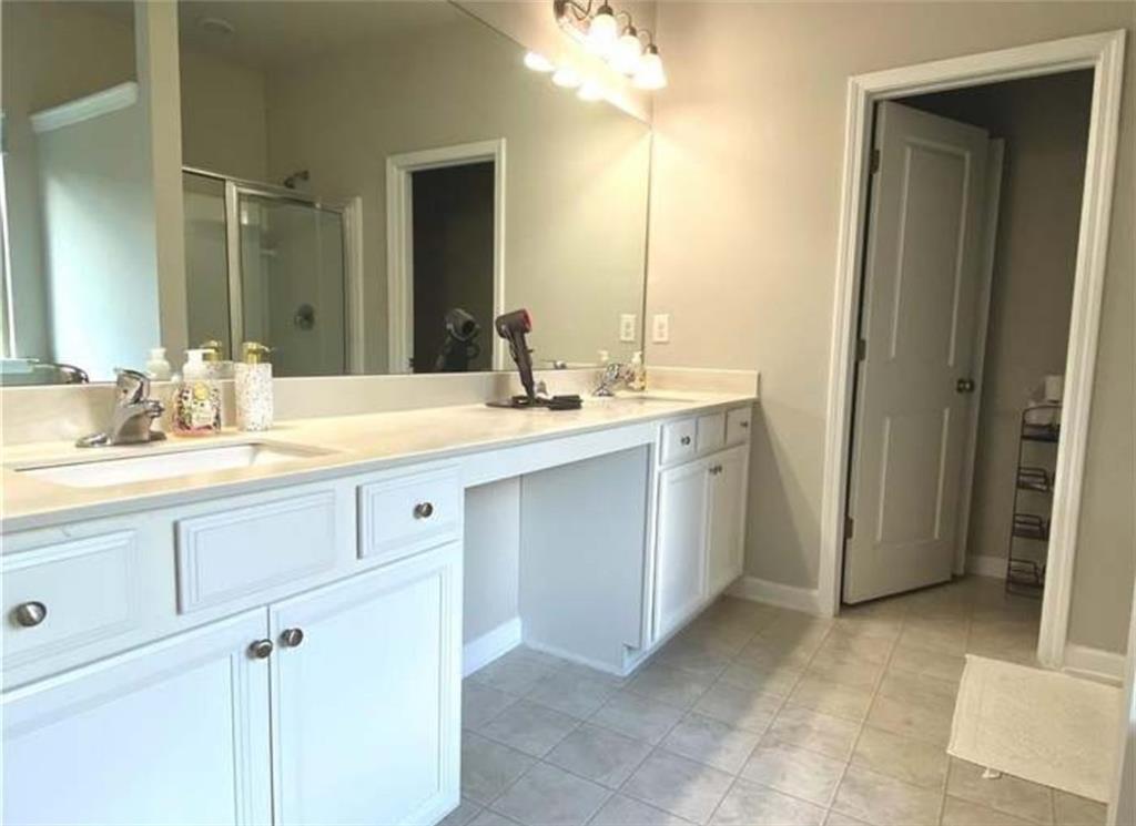 1719 Charcoal Ives Road Lawrenceville, GA 30045 - Photo 7 of 17 a bathroom with a sink and a mirror