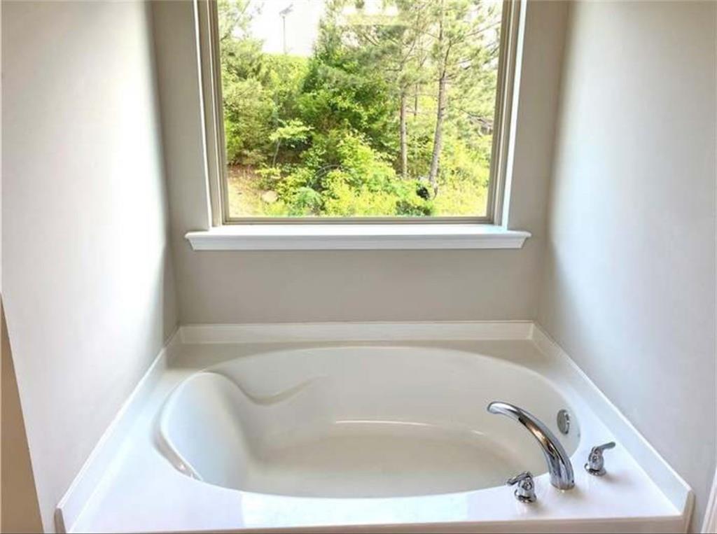 1719 Charcoal Ives Road Lawrenceville, GA 30045 - Photo 8 of 17 a white bath tub sitting in a bathroom