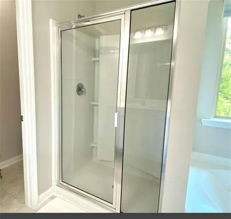 a bathroom with a glass shower door