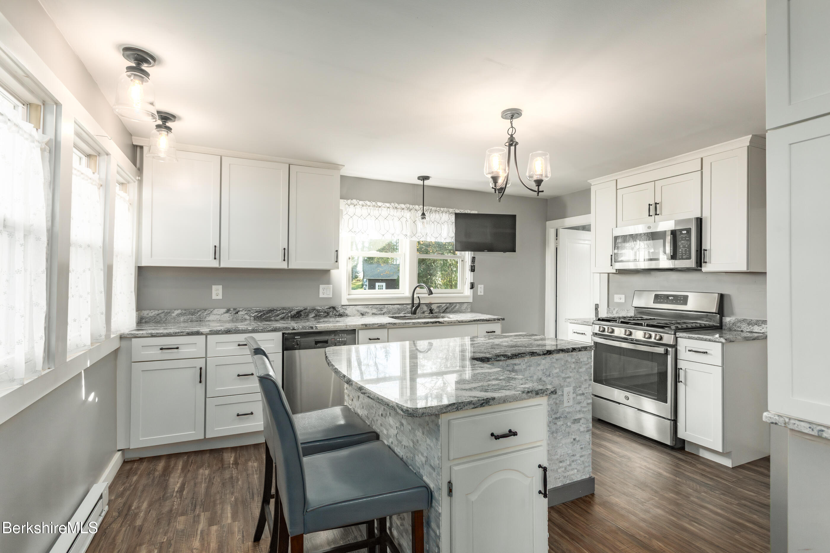 396 Maple Street Hinsdale, MA 01235 - Photo 10 of 47 a kitchen with stainless steel appliances granite countertop a stove top oven a sink dishwasher a dining table and chairs with wooden floor