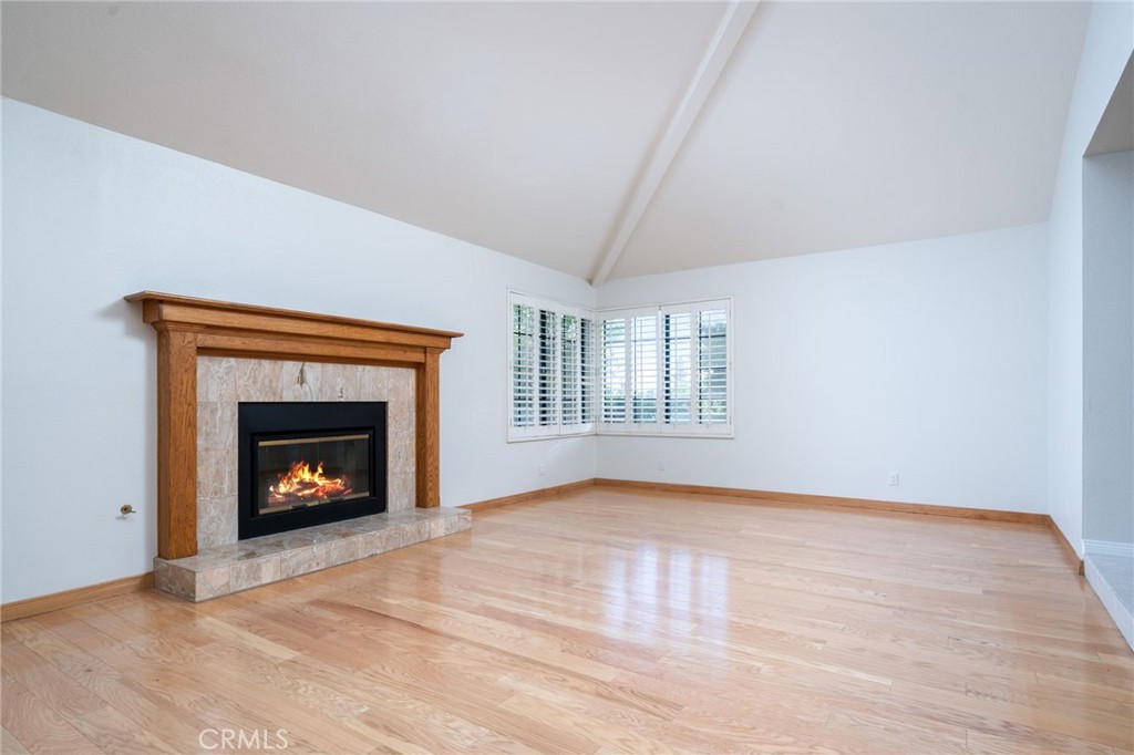 112 Morgan Ranch Road Glendora, CA 91741 - Photo 7 of 58 a view of an empty room with wooden floor fireplace and a window