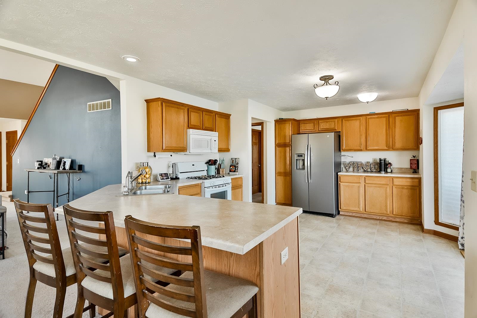 381 Red Fox Drive Davis Junction, IL 61020 - Photo 16 of 38 a large kitchen with a table chairs refrigerator and cabinets