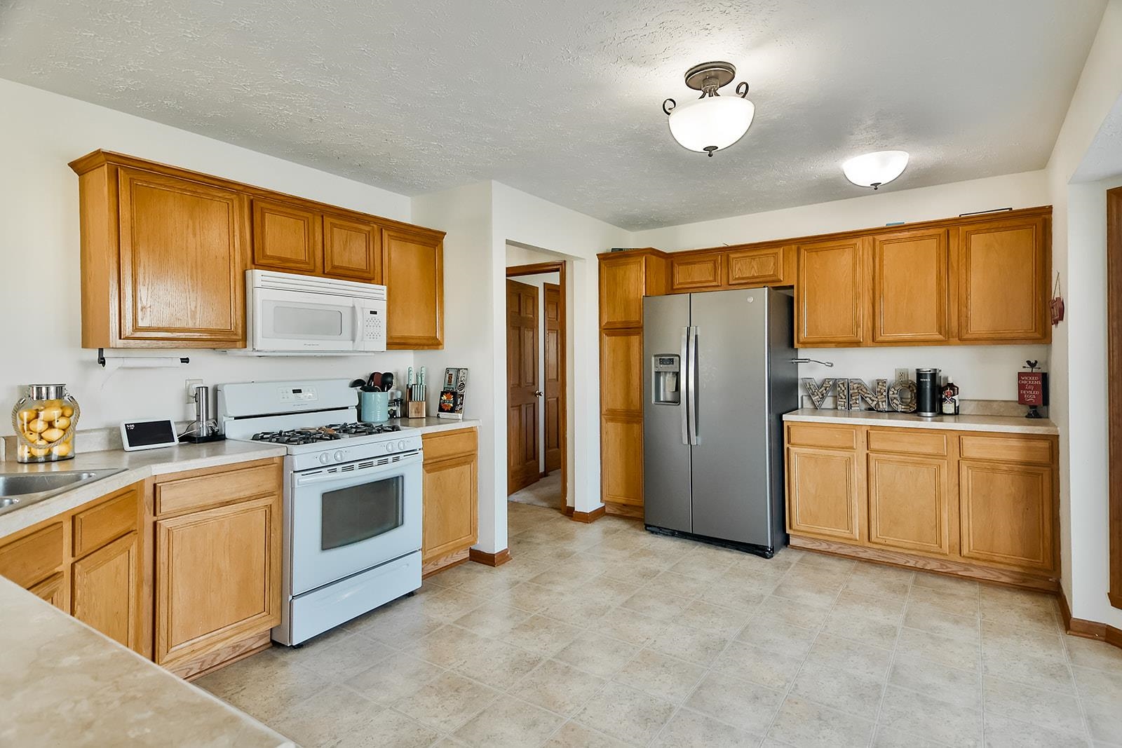 381 Red Fox Drive Davis Junction, IL 61020 - Photo 17 of 38 a kitchen with stainless steel appliances granite countertop a stove a sink dishwasher a refrigerator and cabinets with wooden floor