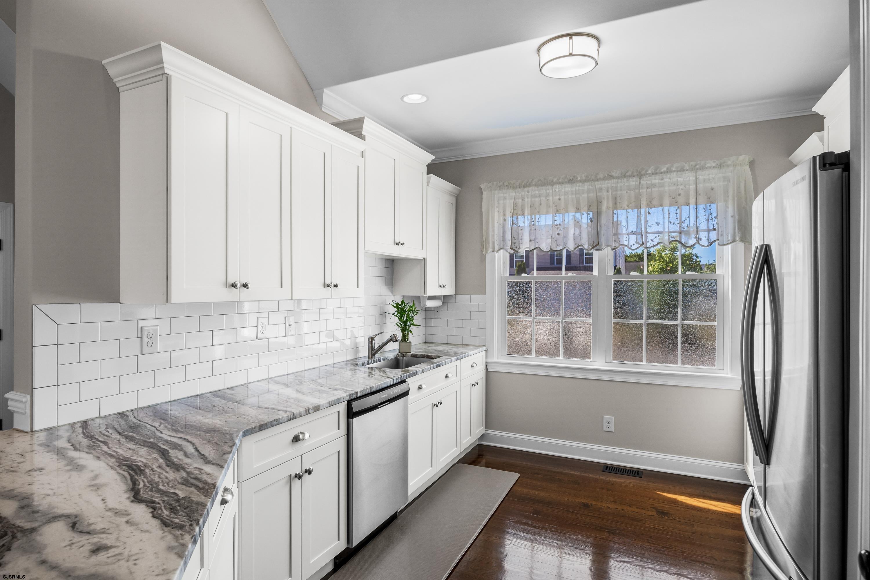 215 Surf Road Egg Harbor Township, NJ 08234 - Photo 12 of 31 a kitchen with granite countertop a sink and a refrigerator