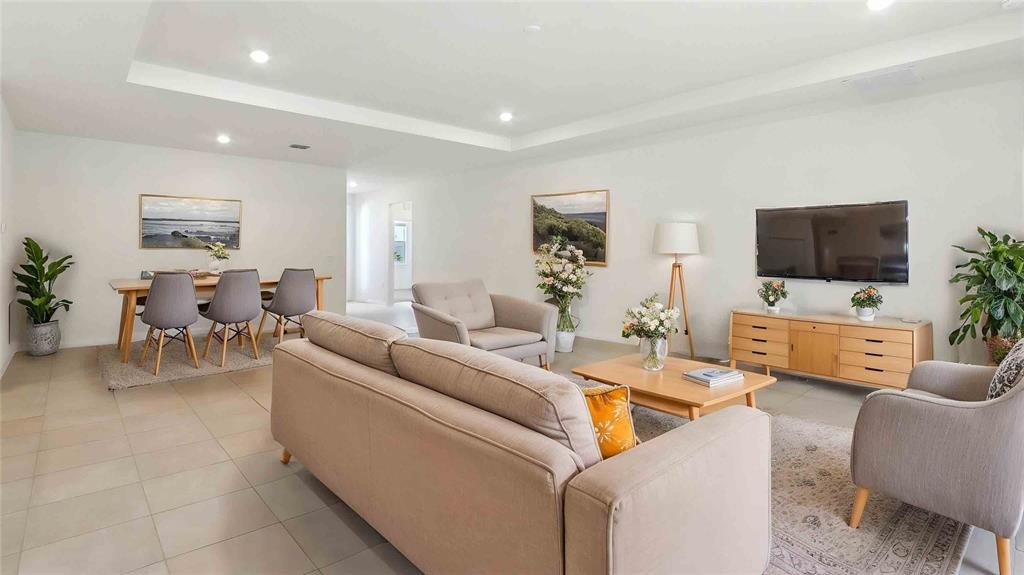 12773 Northwest 13th Lane Gainesville, FL 32606 - Photo 2 of 24 a living room with furniture and a flat screen tv