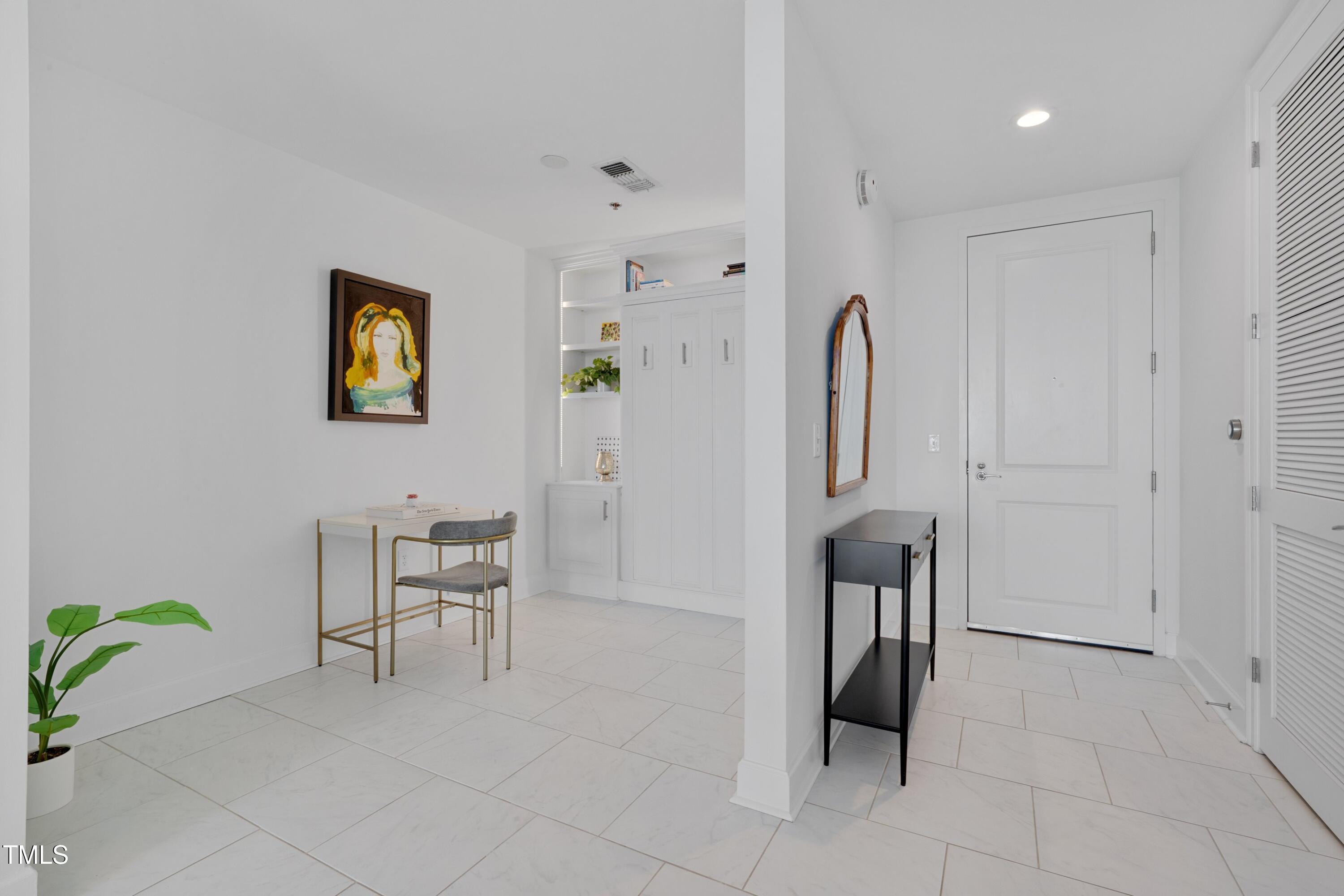 301 Fayetteville Street, Unit 2611 Raleigh, NC 27601 - Photo 13 of 44 a spacious bedroom with a bed and a table in it