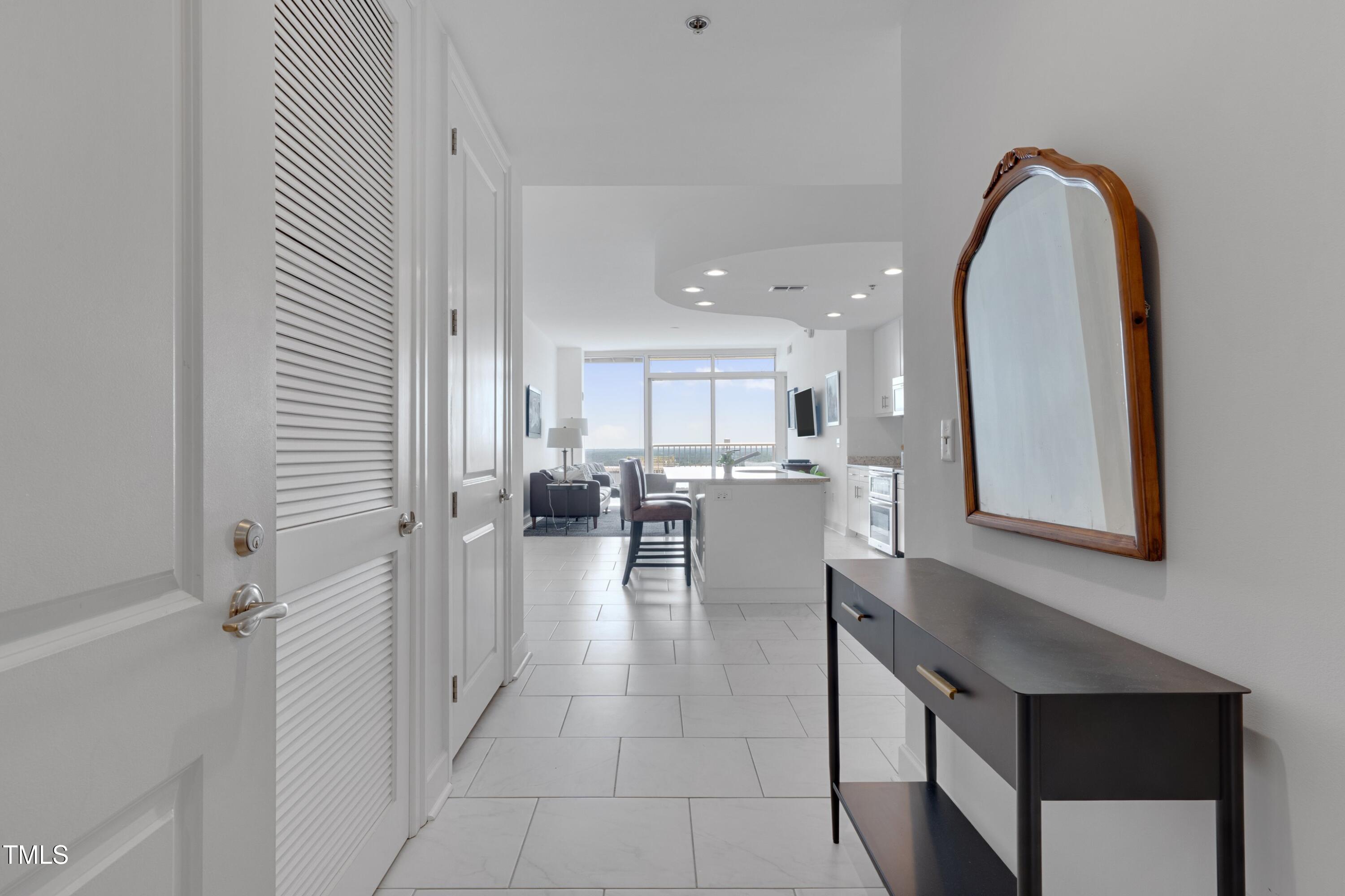 301 Fayetteville Street, Unit 2611 Raleigh, NC 27601 - Photo 14 of 44 a view of a kitchen with kitchen island and living room