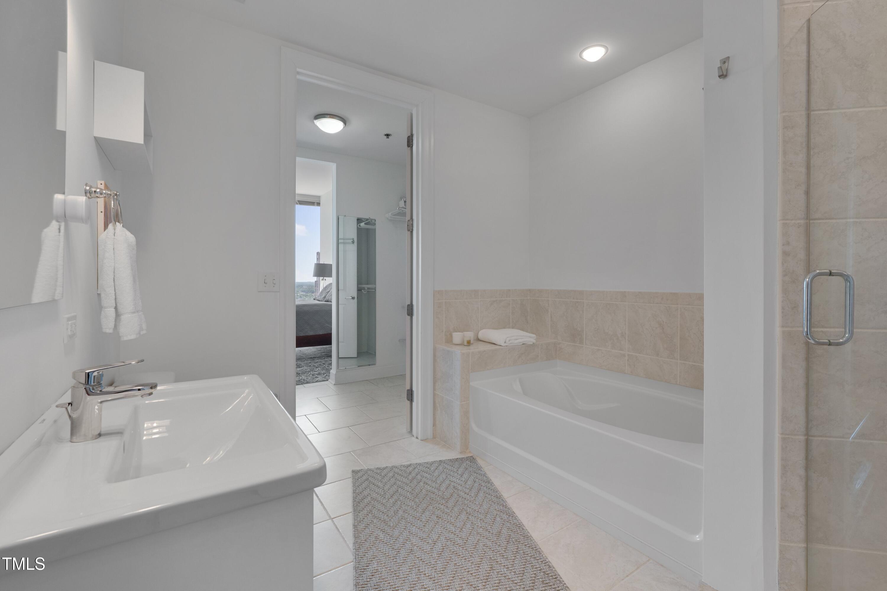 301 Fayetteville Street, Unit 2611 Raleigh, NC 27601 - Photo 22 of 44 a bathroom with a bathtub and a sink
