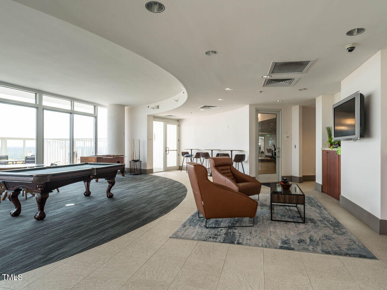301 Fayetteville Street, Unit 2611 Raleigh, NC 27601 - Photo 36 of 44 a living room with furniture a flat screen tv and a table